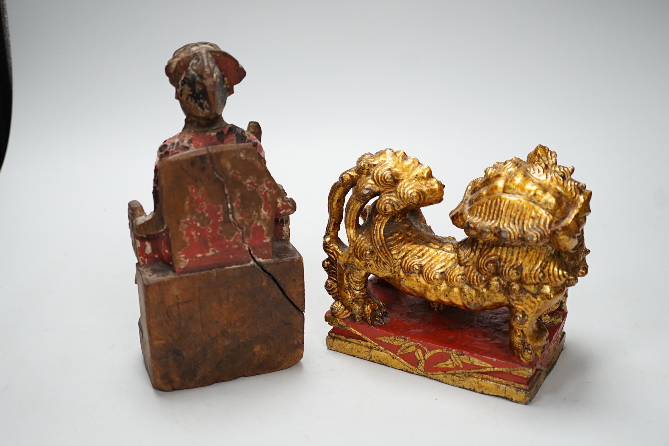 A Chinese lacquered wood figure of a seated woman and a Buddhist lion, tallest 20.5cm